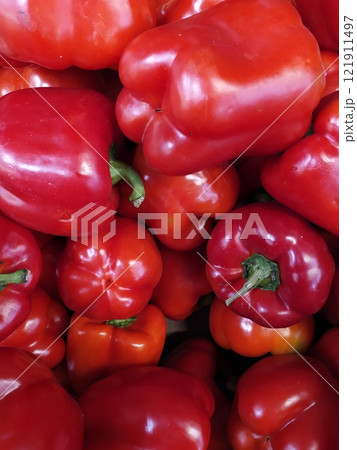 Red bright shiny peppers lie 121911497