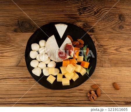 Cheese plate of color cheeses variety, yellow, white and blue cheese board, assorted dairy products 121911605