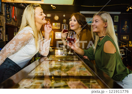 Girls with alcohol glasses in pub club Girls with alcohol glasses in pub club 121911776