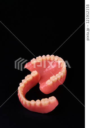 A close up of a denture on a black background for macro photography 121912158