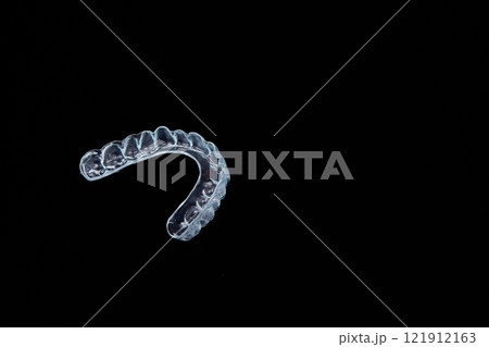 Clear mouth guard on black background with font, art, fashion, metal keywords Clear mouth guard on black background with font, art, fashion, metal keywords 121912163