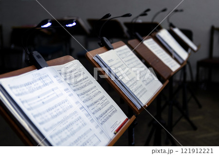Music stands with musical notes in a rehearsal room Music stands with musical notes in a rehearsal room 121912221