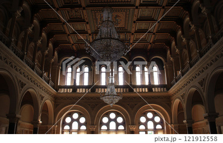 Columns support balconies in an ancient throne room with a carved ceiling Columns support balconies in an ancient throne room with a carved ceiling 121912558