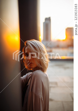Young woman posing in roof, amazing view of city from roof. . Fashion, style concept. Lifestyle. Young woman posing in roof, amazing view of city from roof. . Fashion, style concept. Lifestyle. 121913163