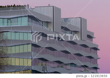 Colorful sunset light on glass building 121913650