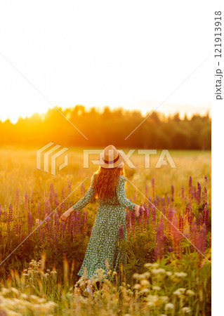 Beautiful woman in style dress on blooming fragrant lavender fields. Nature, vacation, lifestyle Beautiful woman in style dress on blooming fragrant lavender fields. Nature, vacation, lifestyle 121913918