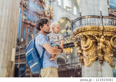 Father and his son tourists exploring the Metropolitan Cathedral in Mexico City. Woman admiring the architecture and history of Mexico's iconic landmark. Concept of cultural heritage, religious Father and his son tourists exploring the Metropolitan Cathedral in Mexico City. Woman admiring the architecture and history of Mexico's iconic landmark. Concept of cultural heritage, religious 121915081