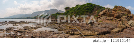 Panoramic View of Rocky Coastal Landscape with Verdant Cliffs 121915144