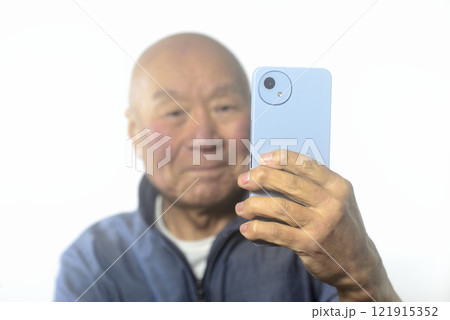 笑顔でスマートフォンを操作する老人 笑顔でスマートフォンを操作する老人 121915352