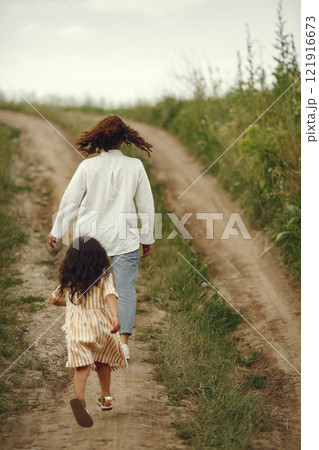 Family in a summer field. Sensual photo. Cute little girl. 121916673