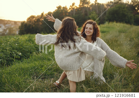 Family in a summer field. Sensual photo. Cute little girl in a knited sweater. Family in a summer field. Sensual photo. Cute little girl in a knited sweater. 121916681