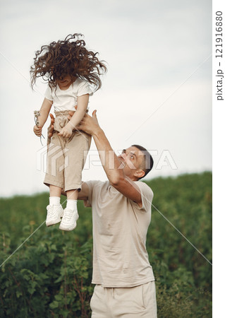 Family in a summer park. Father in a white t-shirt. Cute little daughter 121916880