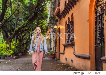 Woman tourist exploring lush streets of Condesa, Mexico City. Family adventure in a vibrant urban oasis. Travel, family bonding, and urban greenery concept in Latin America 121916936