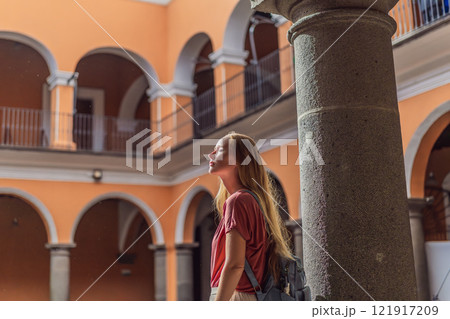 Female tourist exploring the historic Biblioteca Palafoxiana Palafoxiana Library in Puebla, Mexico. A cultural journey through history and literature in a UNESCO World Heritage site 121917209