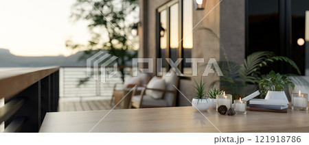 A wooden table with a blurred background of a cozy luxurious home balcony. 121918786