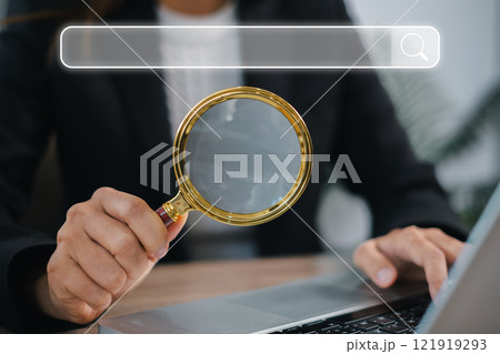 Search Engine Optimization Concept with Magnifying Glass and Search Bar on Laptop for Digital Marketing and Online Visibility 121919293