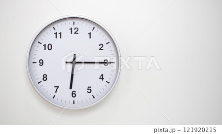 Minimalist White Clock with Silver Frame Striking 18.15/06.15 on White Background. Perfect for Time Management and Corporate Campaigns Minimalist White Clock with Silver Frame Striking 18.15/06.15 on White Background. Perfect for Time Management and Corporate Campaigns 121920215