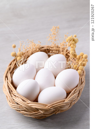 White eggs in basket on white background 121920267