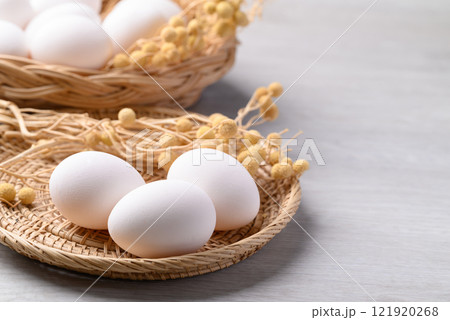 White eggs in basket on white background White eggs in basket on white background 121920268