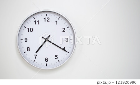 Minimalist White Clock with Silver Frame Striking 19.20/07.20 on White Background. Perfect for Time Management and Corporate Campaigns 121920990