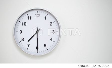 Minimalist White Clock with Silver Frame Striking 19.30/07.30 on White Background. Perfect for Time Management and Corporate Campaigns Minimalist White Clock with Silver Frame Striking 19.30/07.30 on White Background. Perfect for Time Management and Corporate Campaigns 121920992