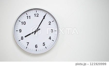 Minimalist White Clock with Silver Frame Striking 20.05/08.05 on White Background. Perfect for Time Management and Corporate Campaigns 121920999
