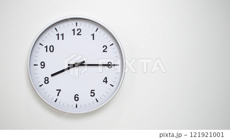 Minimalist White Clock with Silver Frame Striking 20.15/08.15 on White Background. Perfect for Time Management and Corporate Campaigns Minimalist White Clock with Silver Frame Striking 20.15/08.15 on White Background. Perfect for Time Management and Corporate Campaigns 121921001