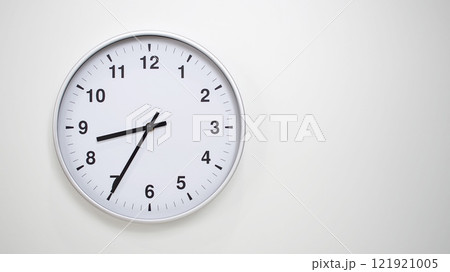 Minimalist White Clock with Silver Frame Striking 20.35/08.35 on White Background. Perfect for Time Management and Corporate Campaigns 121921005