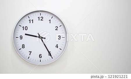 Minimalist White Clock with Silver Frame Striking 21.25/09.25 on White Background. Perfect for Time Management and Corporate Campaigns Minimalist White Clock with Silver Frame Striking 21.25/09.25 on White Background. Perfect for Time Management and Corporate Campaigns 121921221