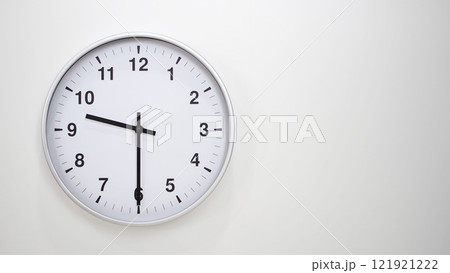 Minimalist White Clock with Silver Frame Striking 21.30/09.30 on White Background. Perfect for Time Management and Corporate Campaigns Minimalist White Clock with Silver Frame Striking 21.30/09.30 on White Background. Perfect for Time Management and Corporate Campaigns 121921222