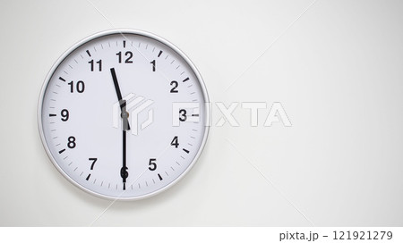 Minimalist White Clock with Silver Frame Striking 23.30/11.30 on White Background. Perfect for Time Management and Corporate Campaigns Minimalist White Clock with Silver Frame Striking 23.30/11.30 on White Background. Perfect for Time Management and Corporate Campaigns 121921279