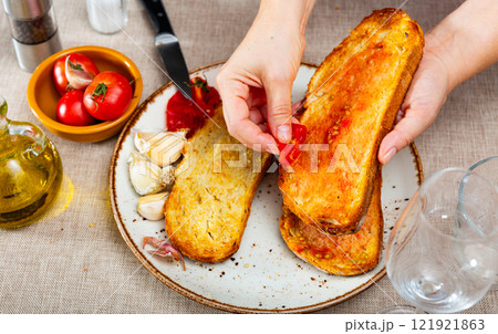 Spanish Pan con Tomate - cook rubs bread with tomatoes 121921863