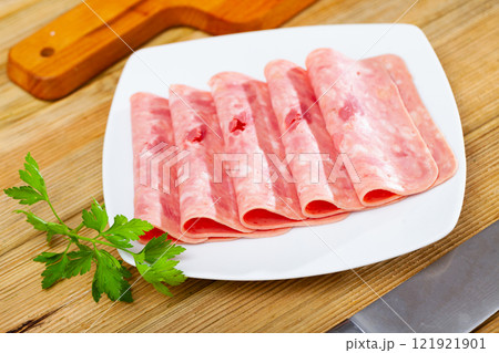 Sliced ham on wooden background 121921901