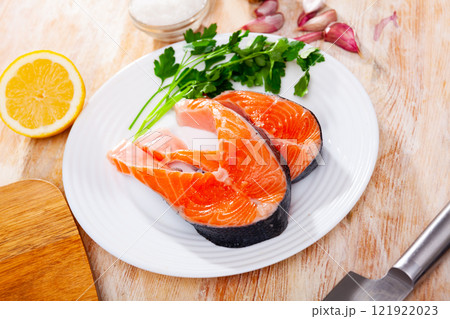 Raw salmon steaks on plate 121922023
