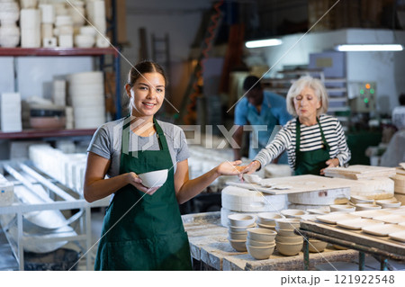 Cheerful young woman ceramist in workshop Cheerful young woman ceramist in workshop 121922548