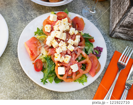 Tomato salad with cheese and olives 121922710