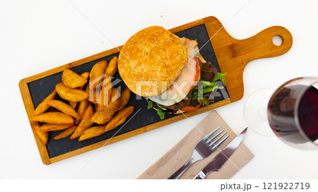 Delicious cheeseburger with beef patty and cheese on plate, with french fries Delicious cheeseburger with beef patty and cheese on plate, with french fries 121922719