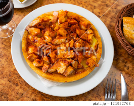 Galician octopus served with potatoes on plate 121922768