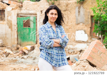 Asian woman near damaged building 121922789