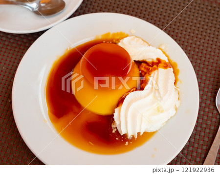 Flan with cream served on table Flan with cream served on table 121922936
