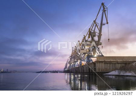 River or sea cargo cranes on the pier in the morning at dawn copyspace . Cargo transportation and logistics River or sea cargo cranes on the pier in the morning at dawn copyspace . Cargo transportation and logistics 121926297