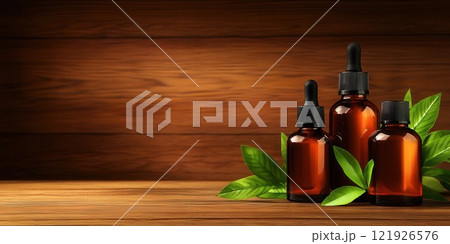 Three Amber Bottles of Essential Oil on Wooden Background 121926576