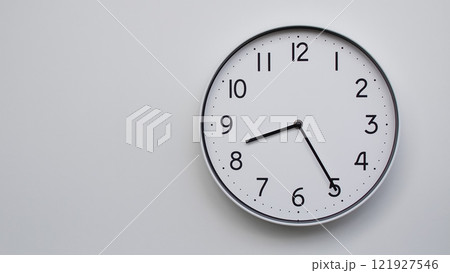 Minimalist Analog Wall Clock with White Face and Simple Black Hands Showing 20.25/08.25 - Ideal for Time Management and Modern Decor Concepts 121927546