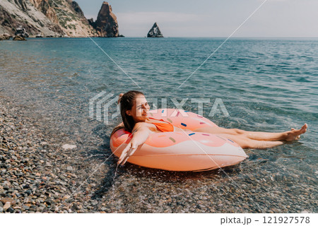 Woman Beach Flamingo Float Relaxing on Calm Sea Water 121927578