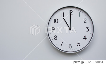 Minimalist Analog Wall Clock with White Face and Simple Black Hands Showing 11.00/23.00 - Ideal for Time Management and Modern Decor Concepts Minimalist Analog Wall Clock with White Face and Simple Black Hands Showing 11.00/23.00 - Ideal for Time Management and Modern Decor Concepts 121928081
