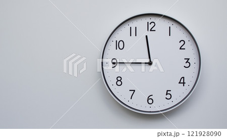 Minimalist Analog Wall Clock with White Face and Simple Black Hands Showing 11.45/23.45 - Ideal for Time Management and Modern Decor Concepts 121928090