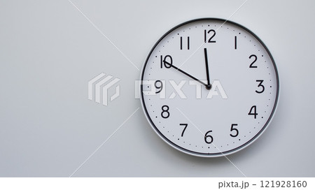 Minimalist Analog Wall Clock with White Face and Simple Black Hands Showing 11.50/23.50 - Ideal for Time Management and Modern Decor Concepts 121928160