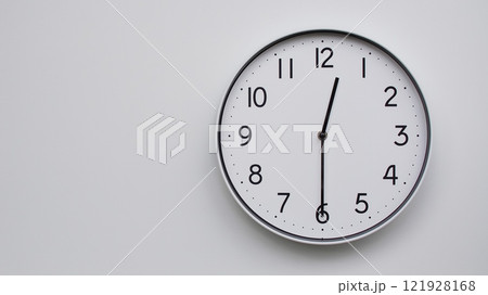 Minimalist Analog Wall Clock with White Face and Simple Black Hands Showing 12.30/00.30 - Ideal for Time Management and Modern Decor Concepts 121928168