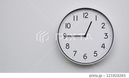 Minimalist Analog Wall Clock with White Face and Simple Black Hands Showing 12.45/00.45 - Ideal for Time Management and Modern Decor Concepts Minimalist Analog Wall Clock with White Face and Simple Black Hands Showing 12.45/00.45 - Ideal for Time Management and Modern Decor Concepts 121928265
