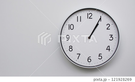 Minimalist Analog Wall Clock with White Face and Simple Black Hands Showing 13.05/01.05 - Ideal for Time Management and Modern Decor Concepts Minimalist Analog Wall Clock with White Face and Simple Black Hands Showing 13.05/01.05 - Ideal for Time Management and Modern Decor Concepts 121928269